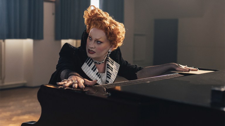 Jinkx Monsoon as Maestro at a piano in Doctor Who The Devils Chord